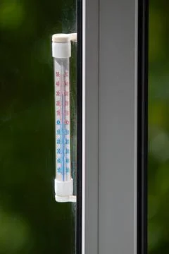 A Celsius thermometer on a window frame shows high temperatures of 32 degrees Stock-Fotos
