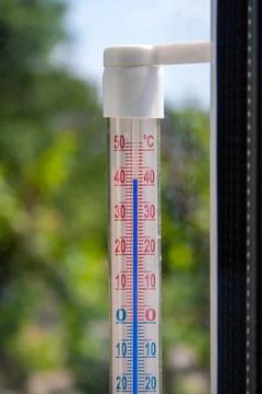 A Celsius thermometer on the window frame shows temperatures up to 42 degrees Stock Photos