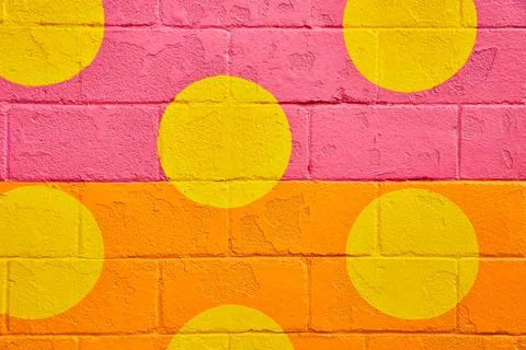 Cement block texture painted with orange and pink and yellow spots Stock-Fotos