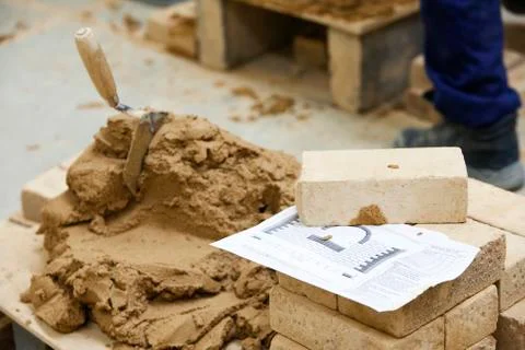 Cement, brick stack and blueprint on top of pallet Foto stock