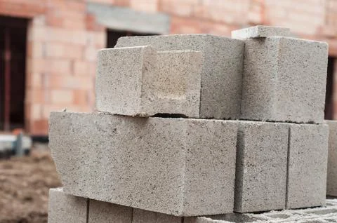 Cement bricks pile in construction site Stock Photos