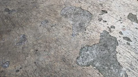 Cement floor with uneven pattern because some of the cement has come off. 스톡 사진