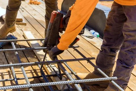 For cement foundations, this tool is used to tie steel bars twisting Stock Photos