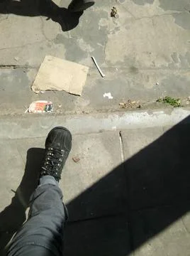 Cement gray sidewalk with different elements in daylight with shadows 库存照片