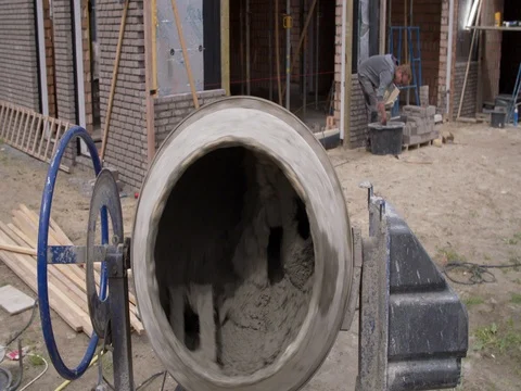 Cement mill working with bricklayer laying bricks in the background Stock Footage 75807803