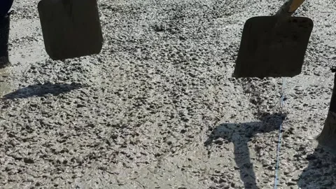 Cement mortar is leveled with shovels Stock-Footage 247268388