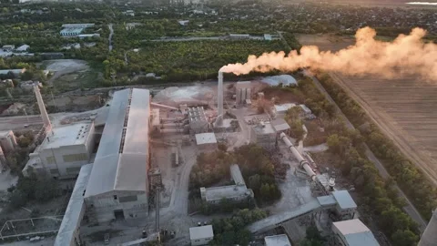 Cement plant exhaust stack plume beside rotary drum dryers in a drone aerial Stock Footage 346923995