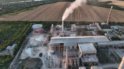 Cement plant stack plume beside farmland in an oblique drone aerial view. Stock Footage 346923460