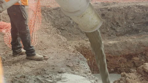 Cement Pours From Funnel Into House Foundations On Building Site Stock Footage 239704853