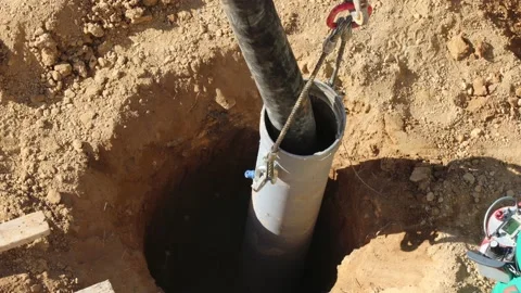 Cement pumping hose is pumping cement into deep foundation hole or column Video stock 224677410