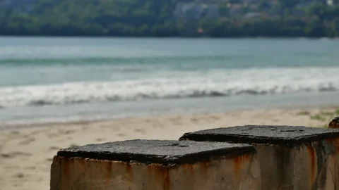 Cement table on sand beach , sea wave hit shore, put your product on the tabl Stock Footage 132020301