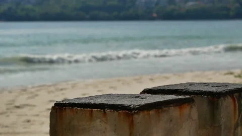 Cement table on sand beach , sea wave hit shore, put your product on the tabl Stock Footage 132020332