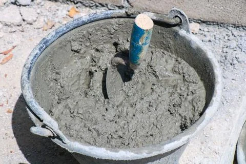 Cement tank and trowel, Mixing a cement in tank for applying construction Stock Photos