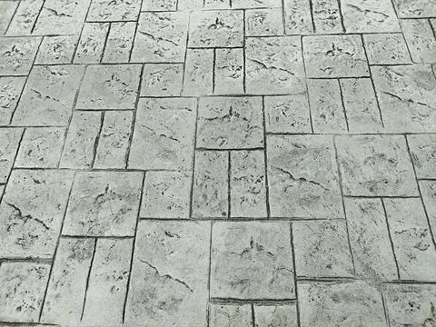 The cement of the walkway is lined up in a pattern Stock Photos