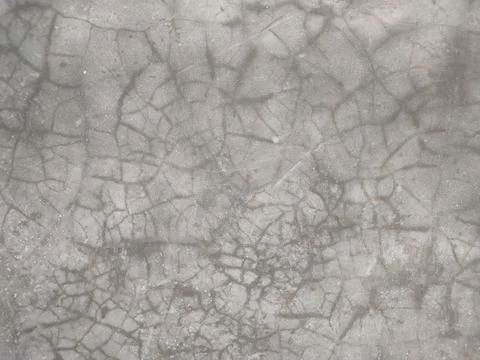The cement wall background is bright gray and black with a few cracks on th.. Stock Photos