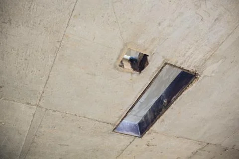 Cement wall with rectangle hole sewerage and electricity wiring Stock Photos