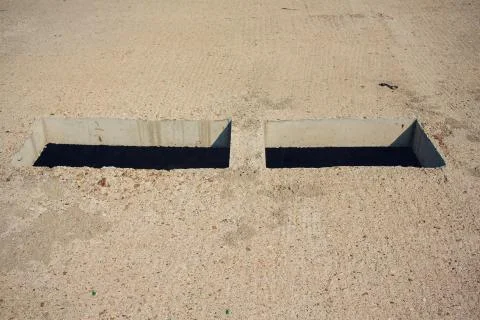Cement wall with rectangle hole sewerage and electricity wiring Foto stock