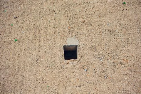 Cement wall with rectangle hole sewerage and electricity wiring Stock Photos