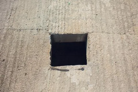 Cement wall with rectangle hole sewerage and electricity wiring 写真素材