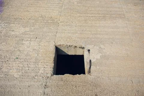 Cement wall with rectangle hole sewerage and electricity wiring Foto stock