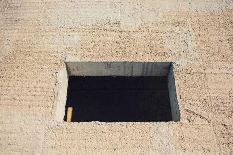 Cement wall with rectangle hole sewerage and electricity wiring Foto stock