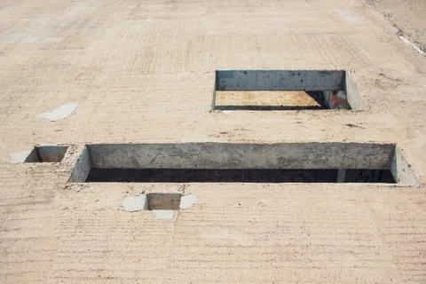 Cement wall with rectangle hole sewerage and electricity wiring 写真素材