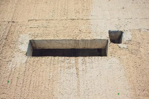 Cement wall with rectangle hole sewerage and electricity wiring Foto stock