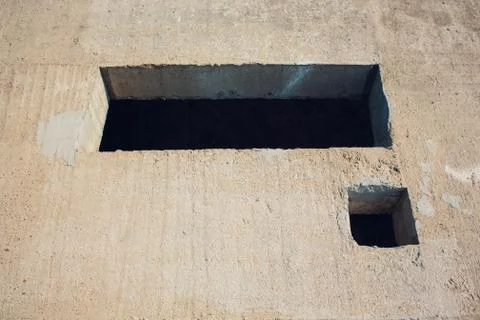 Cement wall with rectangle hole sewerage and electricity wiring Foto stock