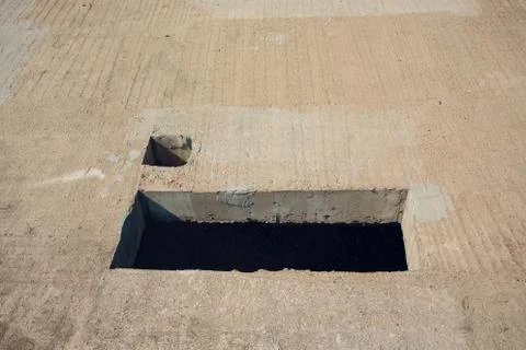 Cement wall with rectangle hole sewerage and electricity wiring Foto stock