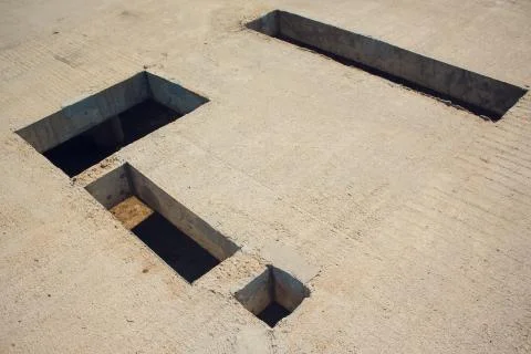 Cement wall with rectangle hole sewerage and electricity wiring 写真素材