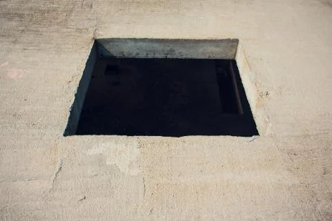 Cement wall with rectangle hole sewerage and electricity wiring Foto stock