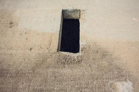 Cement wall with rectangle hole sewerage and electricity wiring 스톡 사진