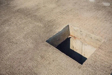 Cement wall with rectangle hole sewerage and electricity wiring Foto stock