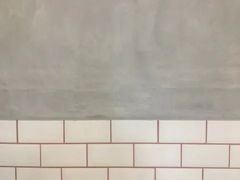 Cement wall texture and ceramic tiles. Stock Photos