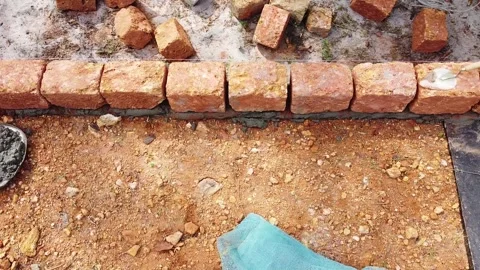 Cemented and jointed earthen blocks are laid, Stacked earthen blocks in Stock Footage 265927981