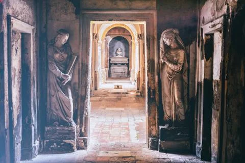 Cemetery corridor background with two statues in a vintage camera film effect Stock Photos