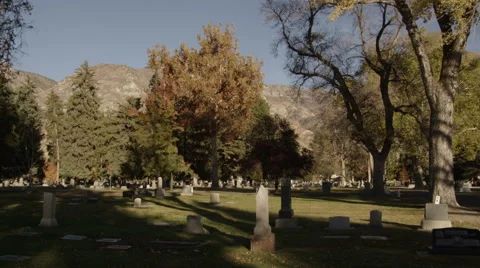 Cemetery in the fall with trees and mountains in the background 動画素材 52499812