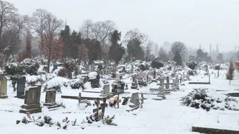 Cemetery or graveyard with graves covered with snow in the cold winter day Stock Footage 146747974
