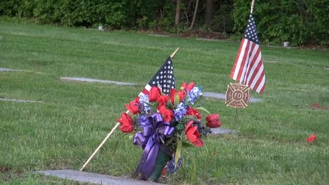Cemetery plot of a US soldier and a firefighter Stock Footage 98710438