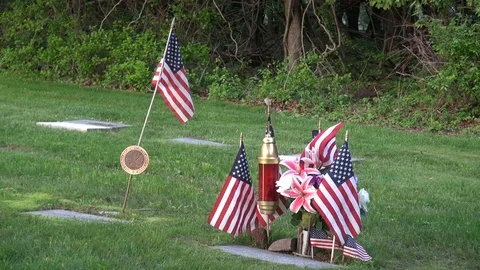Cemetery plot of a US soldier with flags and flowers Stock Footage 98710412