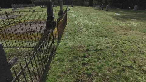 Cemetery reverse walking upwards tilt Stock Footage 86244426