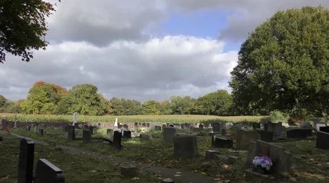 Cemetry graveyard moody sky moving clouds trees rural Stock Footage 57234593