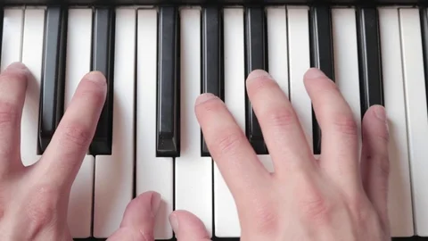 Cenital close-up of a pair of hands playing piano Video stock 106042662