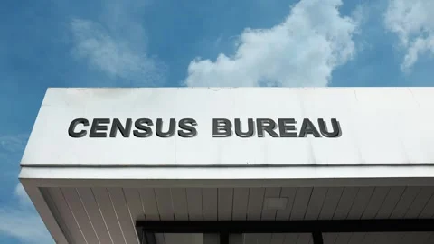 Census Bureau word sign displayed on building with blue sky background Stock Footage 318562524