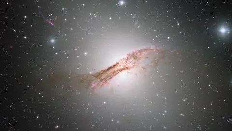 Centaurus A galaxy with its dramatic dust lane and countless distant stars. Stock Footage 311691596