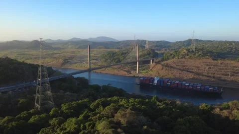 Centennial Bridge and cargo ship in transit at the Panama Canal with Golden hour Stock Footage 330736152