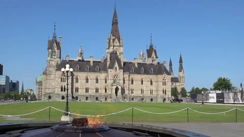 Centennial Flame burning in foreground with historic Parliament Hill building Stock Footage 340319609