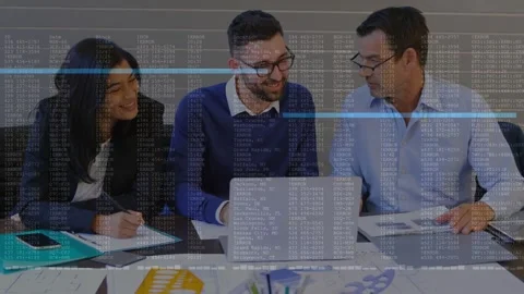 Center analyst typing at table, causing business data overlay across laptop and Stock Footage 333368658