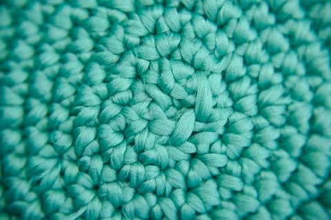 Center focused knitted pattern of green fiber in the shape of vortex Stock Photos