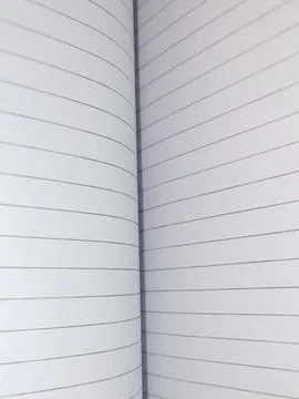 Center fold of an open lined notebook, close up of white paper binding Fotos de archivo